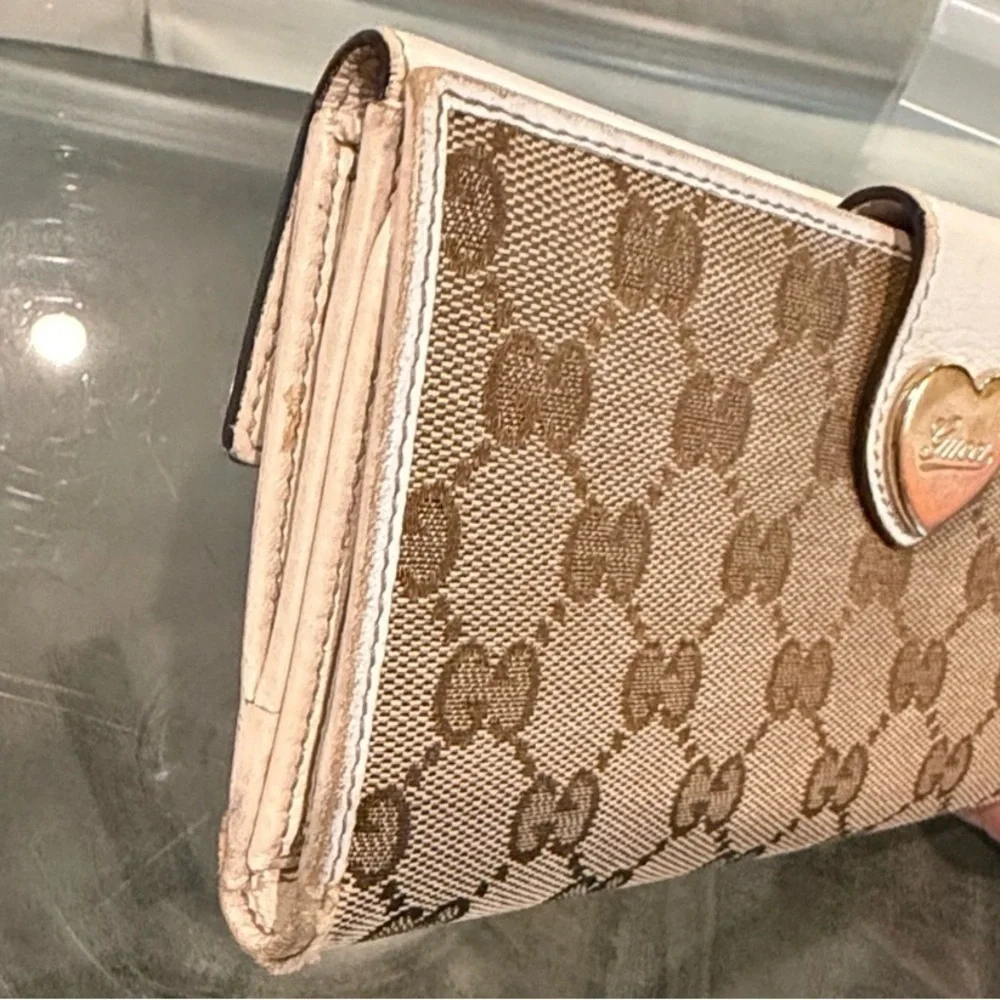Gucci GG Canvas Long Wallet featuring white leather and heart-shaped closure
